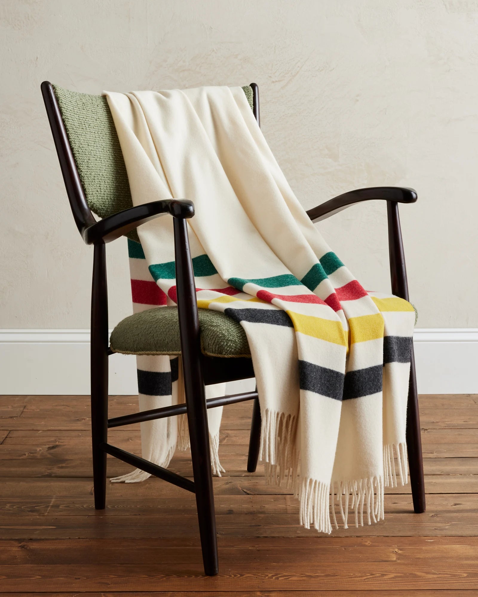 Pendleton 5th Avenue Merino Wool Glacier Park Throw laying on chair