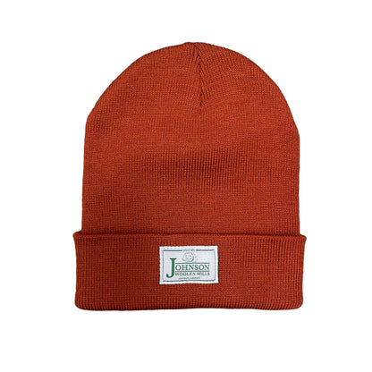 Johnson Woolen Mills beanie in Rust with white label on cuff